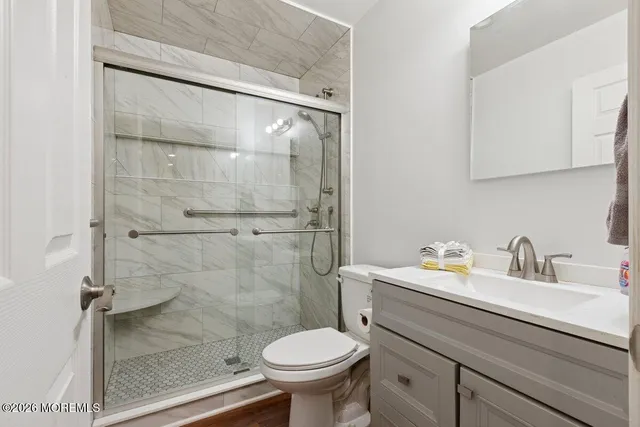 a bathroom with a sink toilet and shower
