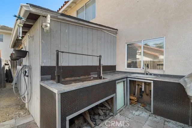 a house with a flower garden and potted plants