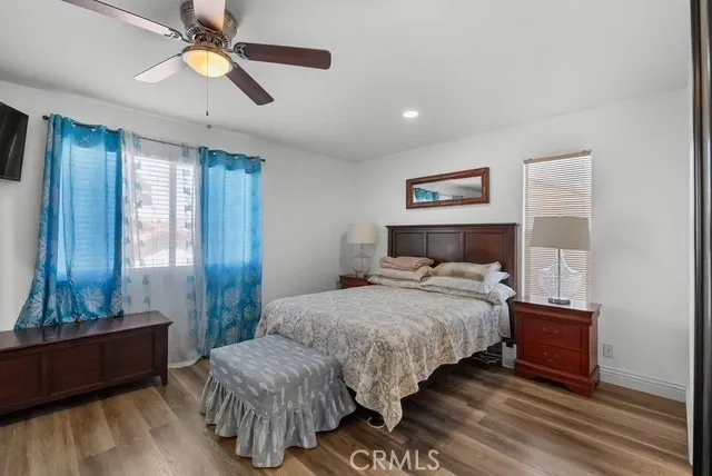 a view of a dining room with furniture a chandelier and wooden floor