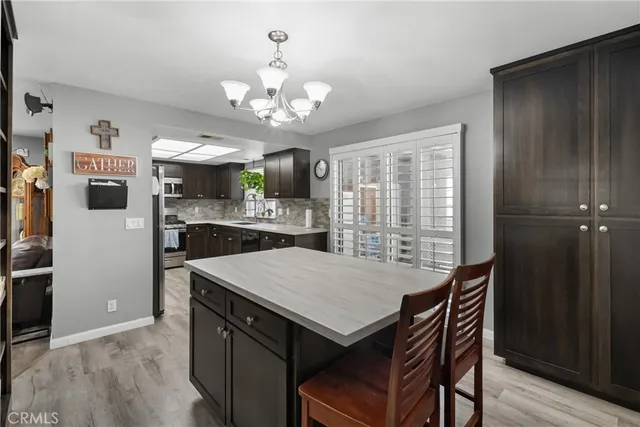 a kitchen with stainless steel appliances granite countertop a sink a stove and a refrigerator