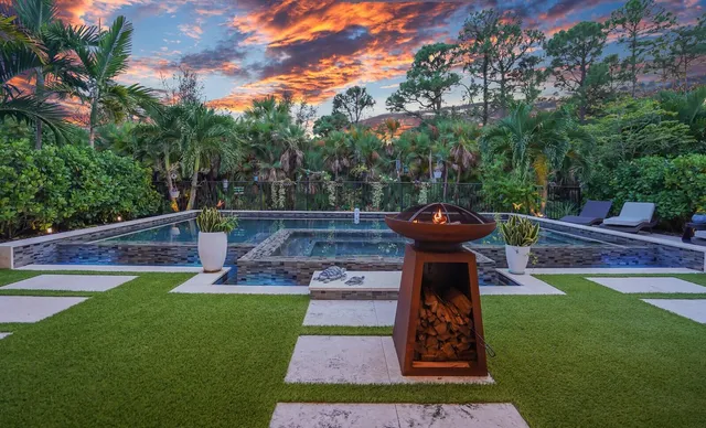 a view of a backyard with sitting area