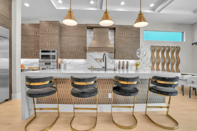 a kitchen with stainless steel appliances granite countertop a refrigerator and a sink