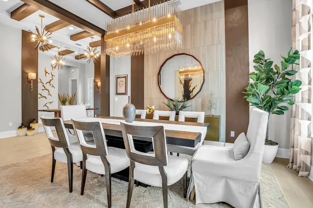 a large white kitchen with a large island in the center