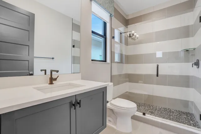 a bathroom with a sink toilet and shower