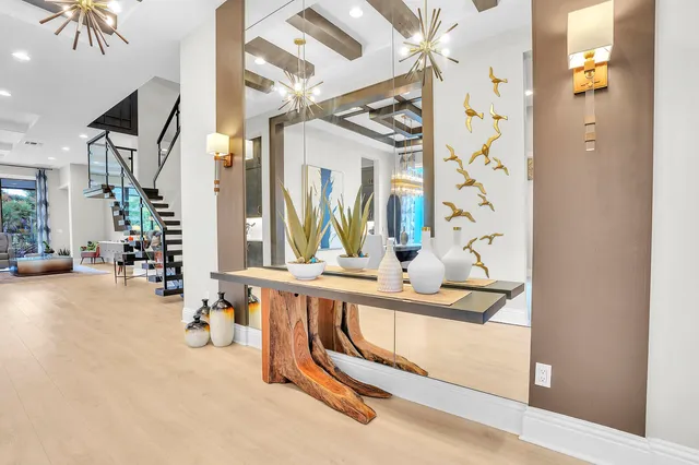 a dining room with furniture and a mirror