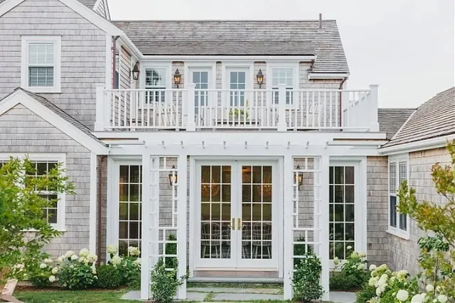 a front view of a house with plants