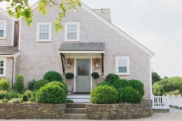 a view of a house with a yard and plants