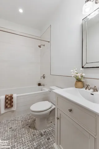 a bedroom with bed and a chair