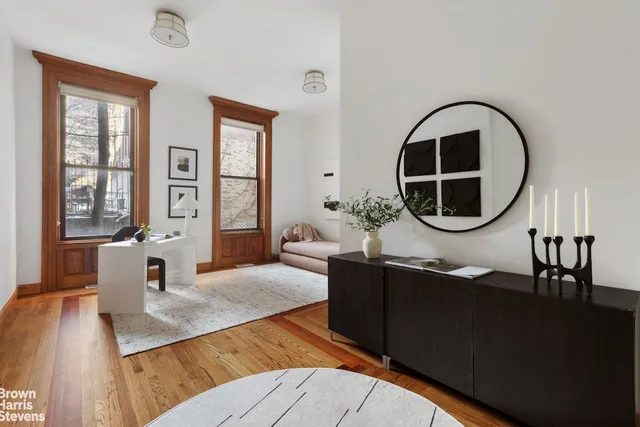 a view of an entryway with wooden floor and cabinet