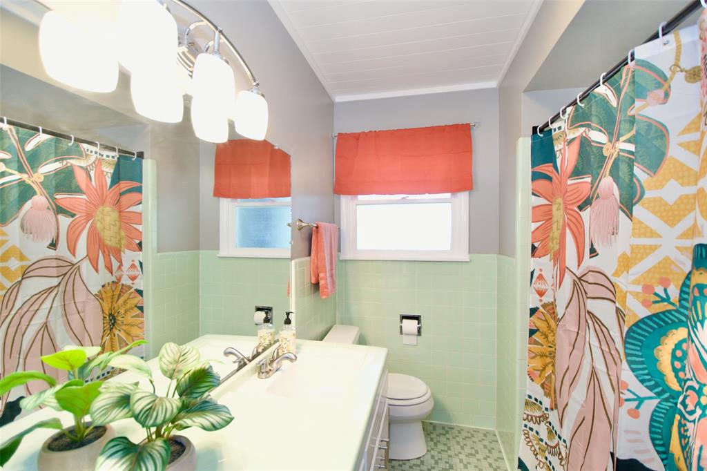 1307 North 65th Street Waco, TX 76710 - Photo 23 of 35 a bathroom with a sink mirror vanity and toilet