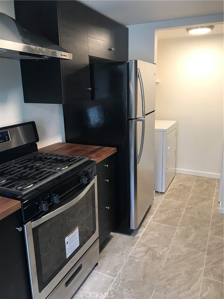 454 East Ave Q3, Unit 5 Palmdale, CA 93550 - Photo 4 of 10 a metallic refrigerator freezer sitting in a kitchen