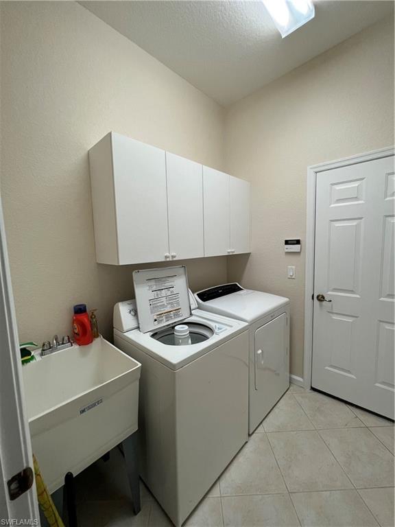 7896 Founders Circle Naples, FL 34104 - Photo 14 of 18 a utility room with dryer and washer