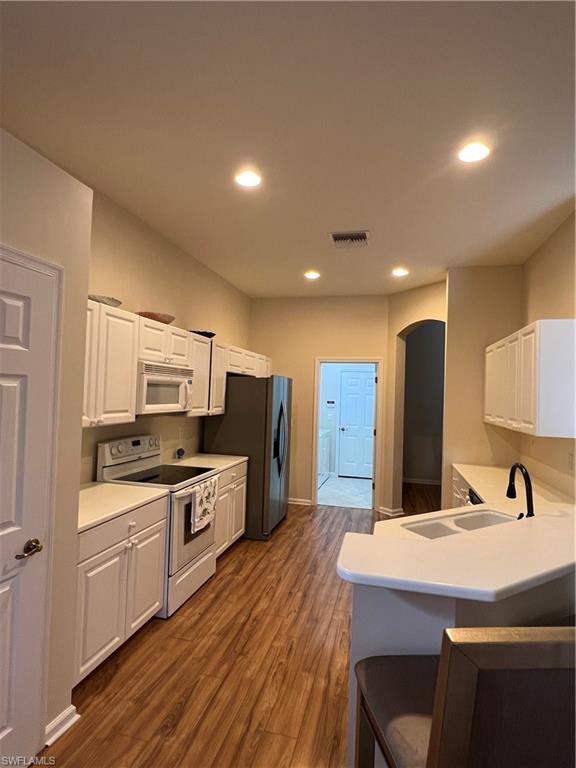 7896 Founders Circle Naples, FL 34104 - Photo 5 of 18 a large kitchen with a kitchen island a sink stainless steel appliances and cabinets
