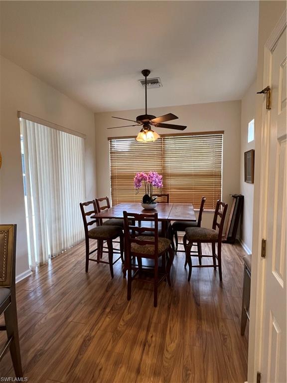7896 Founders Circle Naples, FL 34104 - Photo 7 of 18 a view of a dining room with furniture window and wooden floor