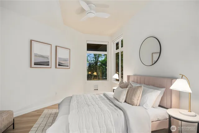 a bedroom with a bed lamp and a window