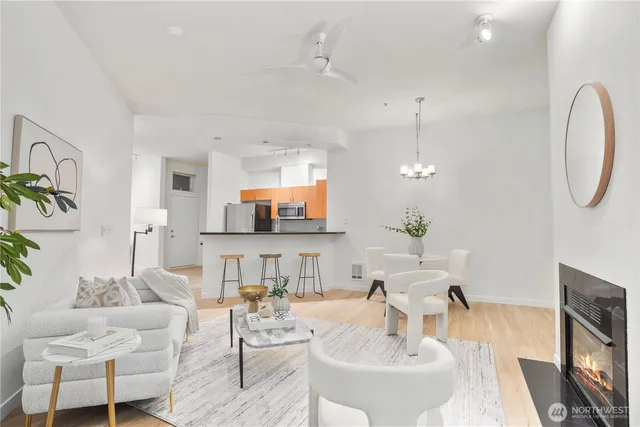 a living room with furniture a chandelier and a flat screen tv