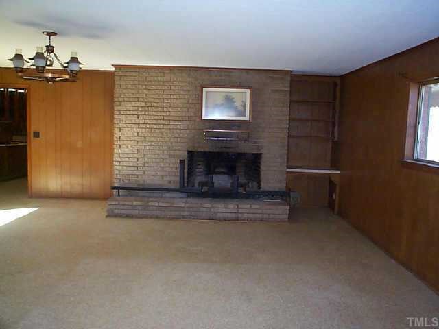 8898 Durham Road Timberlake, NC 27583 - Photo 4 of 10 a view of a livingroom with a fireplace and window