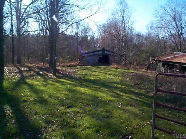 8898 Durham Road Timberlake, NC 27583 - Photo 8 of 10 a backyard of a house with barbeque oven table and chairs