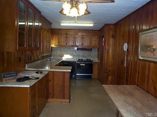 8898 Durham Road Timberlake, NC 27583 - Photo 10 of 10 a kitchen with stainless steel appliances granite countertop a stove a sink dishwasher and a refrigerator