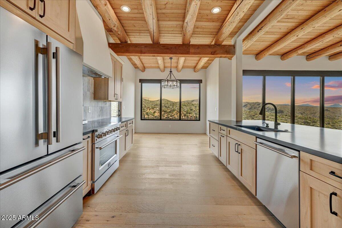 11702 East Blue Wash Road Scottsdale, AZ 85262 - Photo 18 of 50 a large kitchen with kitchen island granite countertop a large window and a counter space