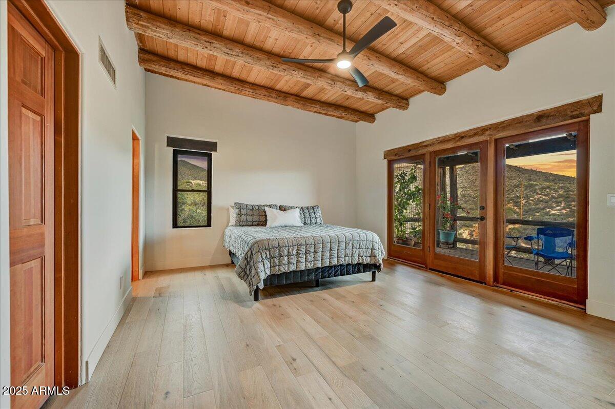 11702 East Blue Wash Road Scottsdale, AZ 85262 - Photo 26 of 50 a bedroom with a bed and wooden floor