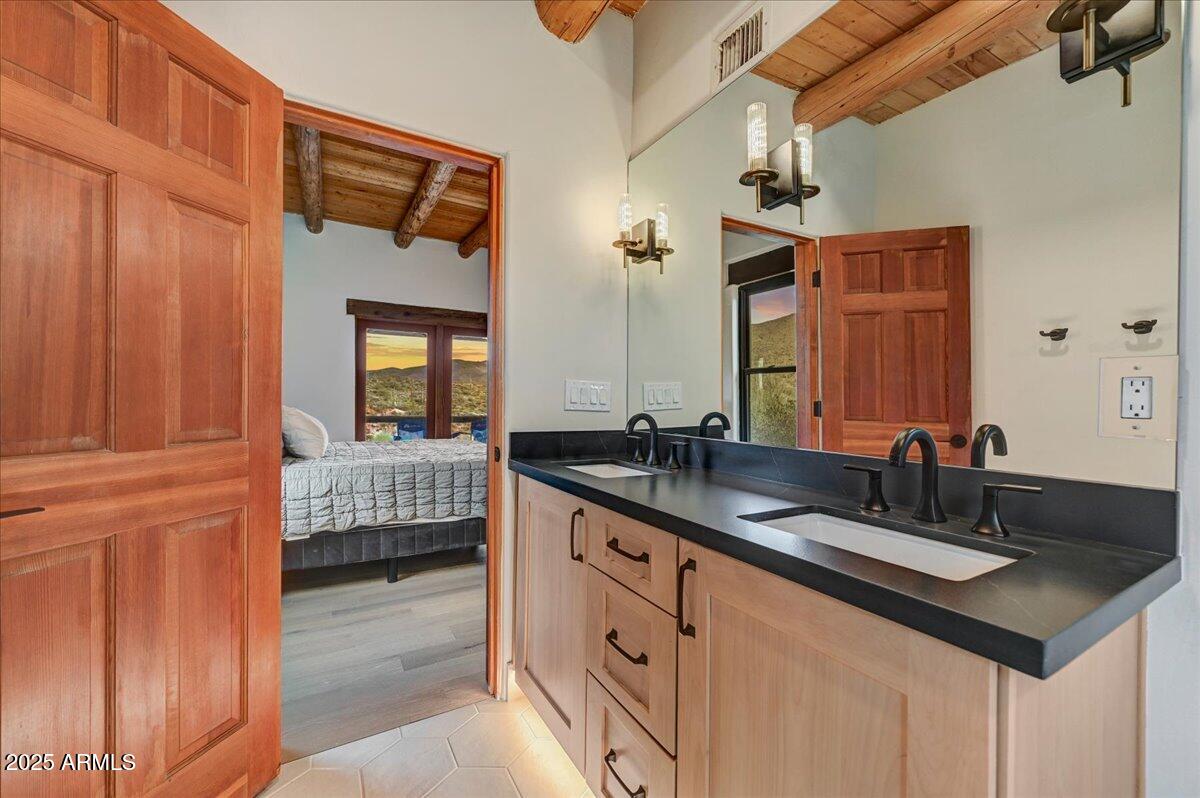 11702 East Blue Wash Road Scottsdale, AZ 85262 - Photo 28 of 50 a en suite bathroom with double sink and a mirror