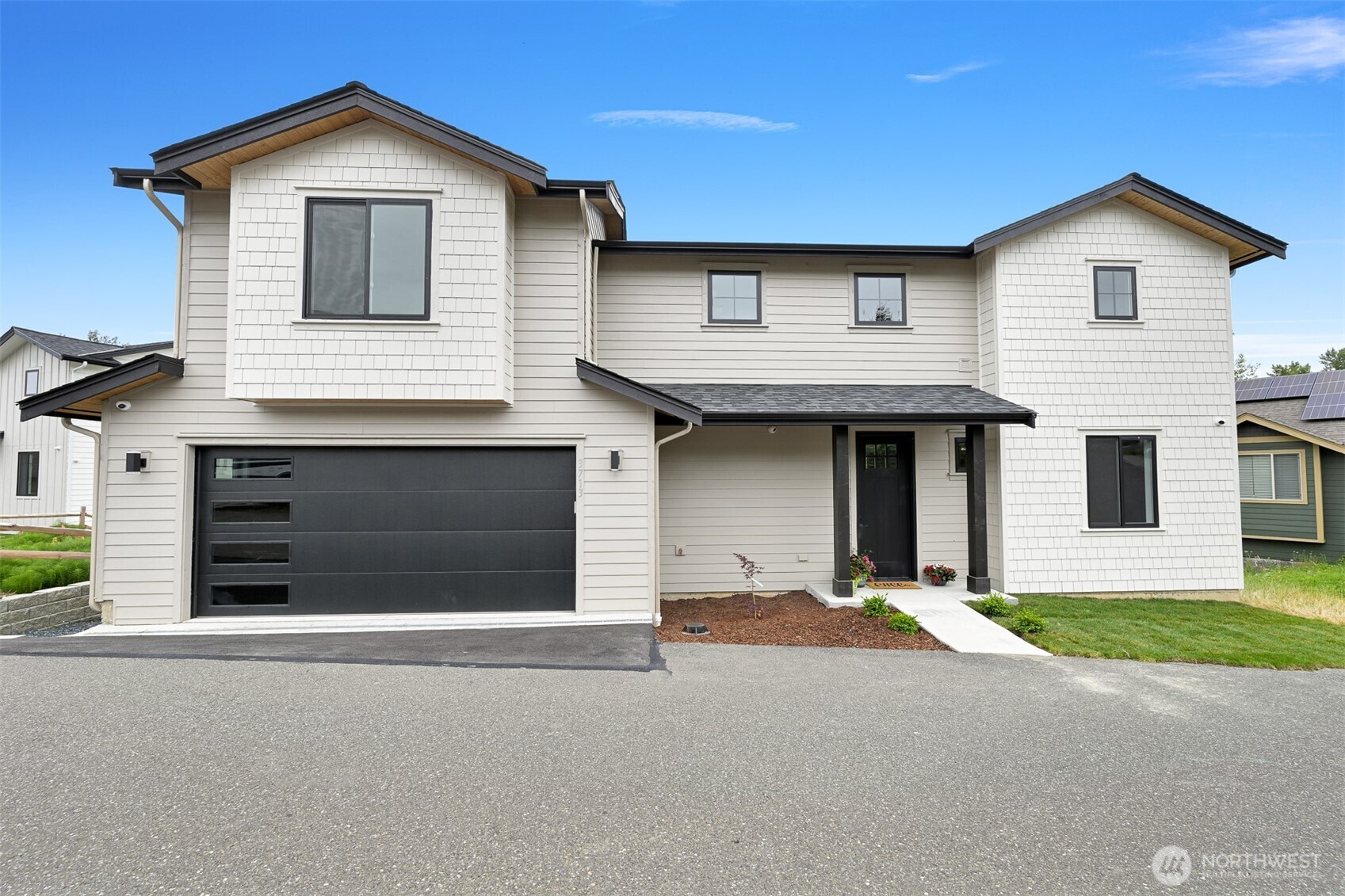 a front view of a house with a yard and garage
