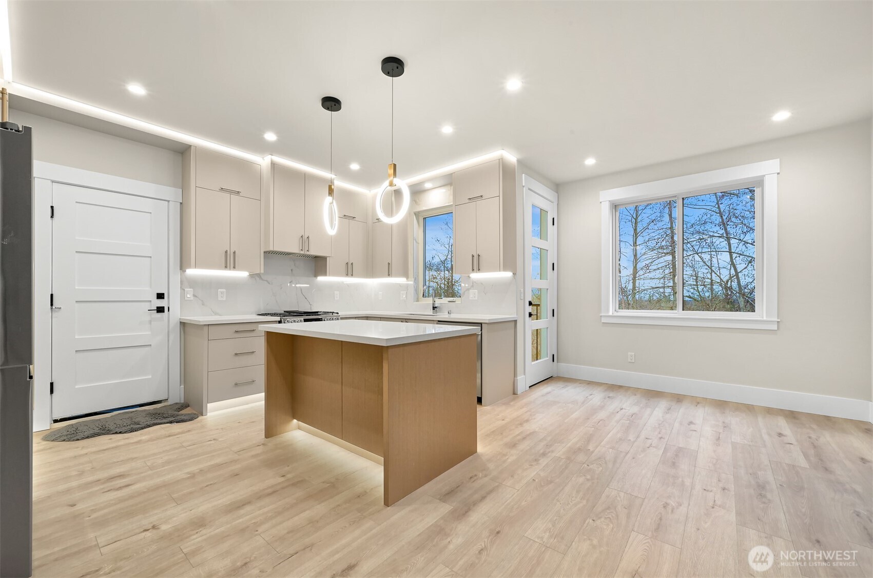 3713 Bristol Street Bellingham, WA 98226 - Photo 5 of 40 a large kitchen with granite countertop a large counter top a sink stainless steel appliances and cabinets