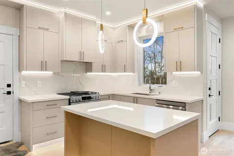 a kitchen with a sink a stove and refrigerator