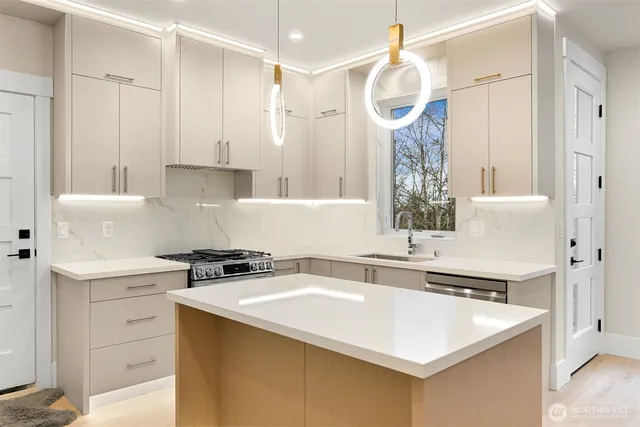 a kitchen with a sink a stove and refrigerator