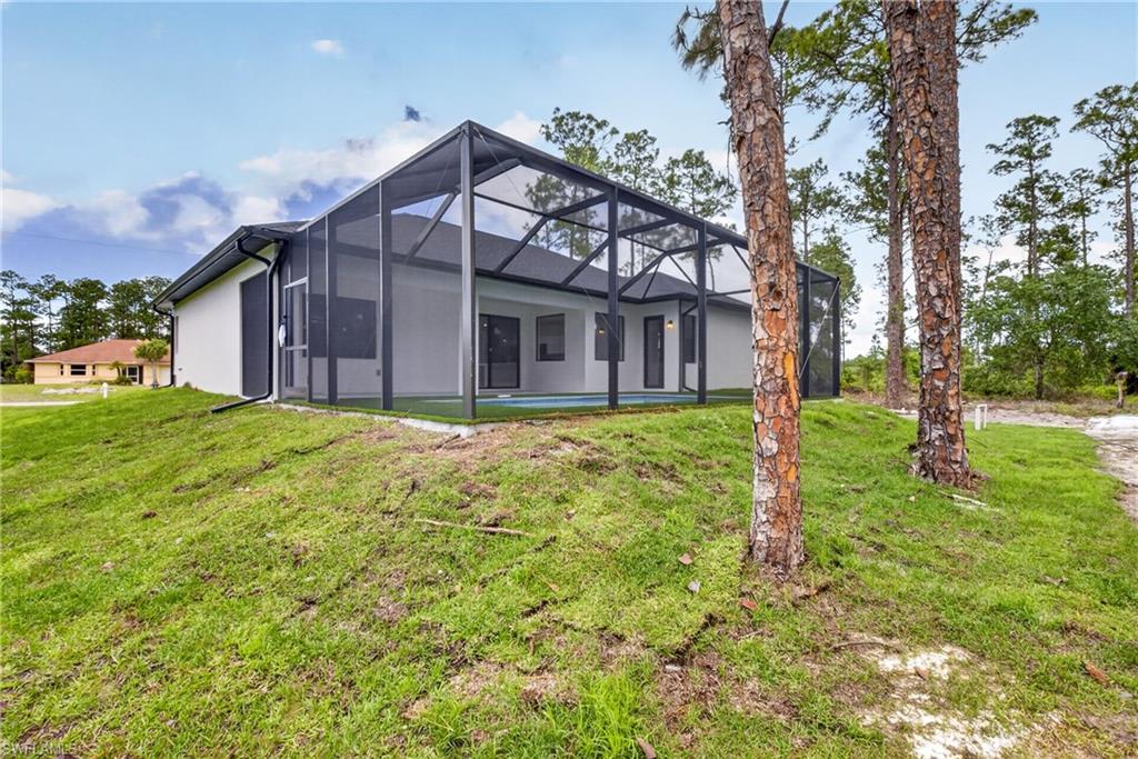 18 Scott Avenue Lehigh Acres, FL 33936 - Photo 6 of 37 a view of a house with a yard