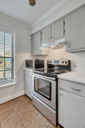 a kitchen with white cabinets stainless steel appliances and sink