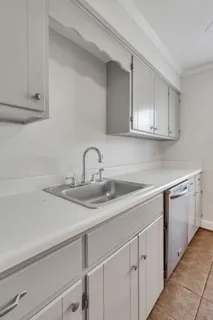 a kitchen with sink and cabinets