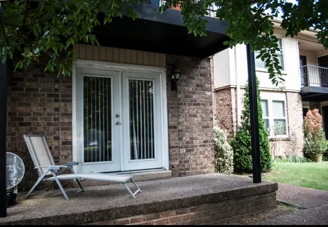 a view of house with backyard and outdoor seating