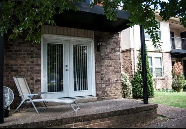 a view of house with backyard and outdoor seating