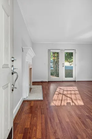 wooden floor in an empty room with a window