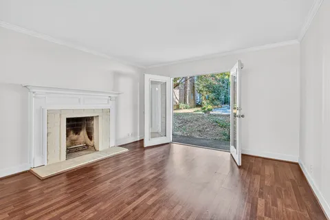 wooden floor fireplace and natural light in room