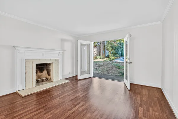 wooden floor fireplace and natural light in room