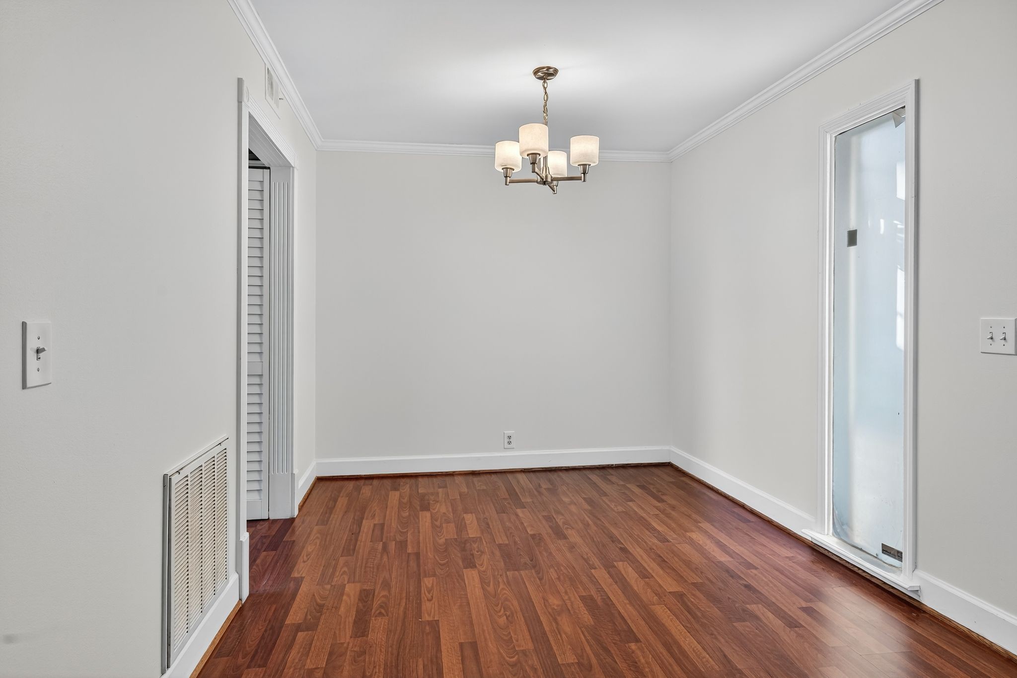 2116 Hobbs Road, Unit M16 Nashville, TN 37215 - Photo 7 of 24 an empty room with wooden floor and chandelier