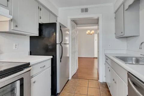 a kitchen with a sink and a refrigerator