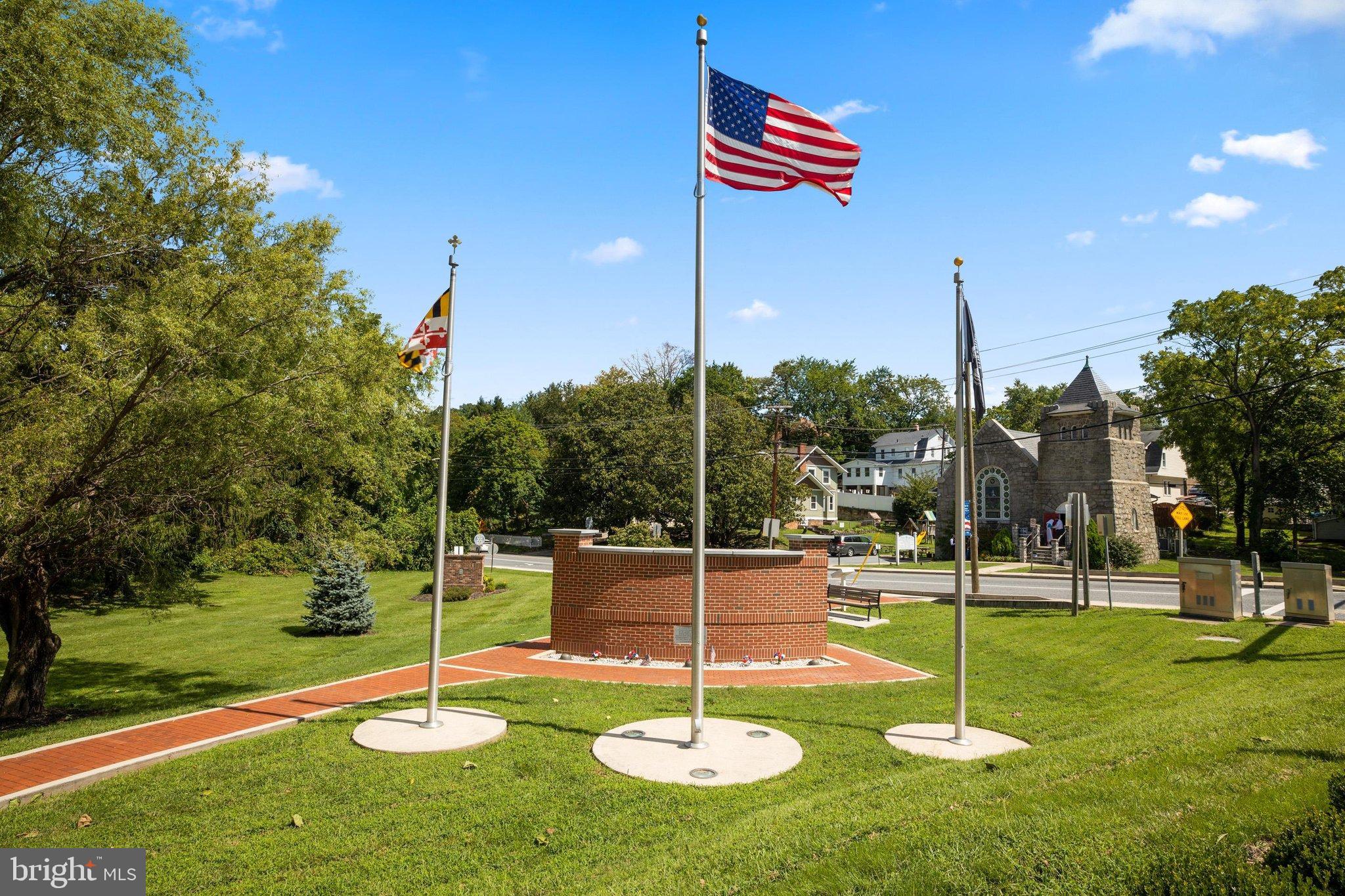 522 Old Hammonds Ferry Road Linthicum Heights, MD 21090 - Photo 80 of 109 Flags proudly wave in a serene park setting.