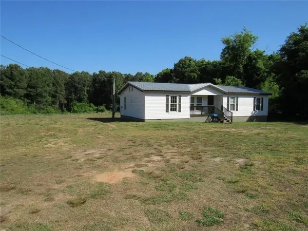 a view of a house with a big yard
