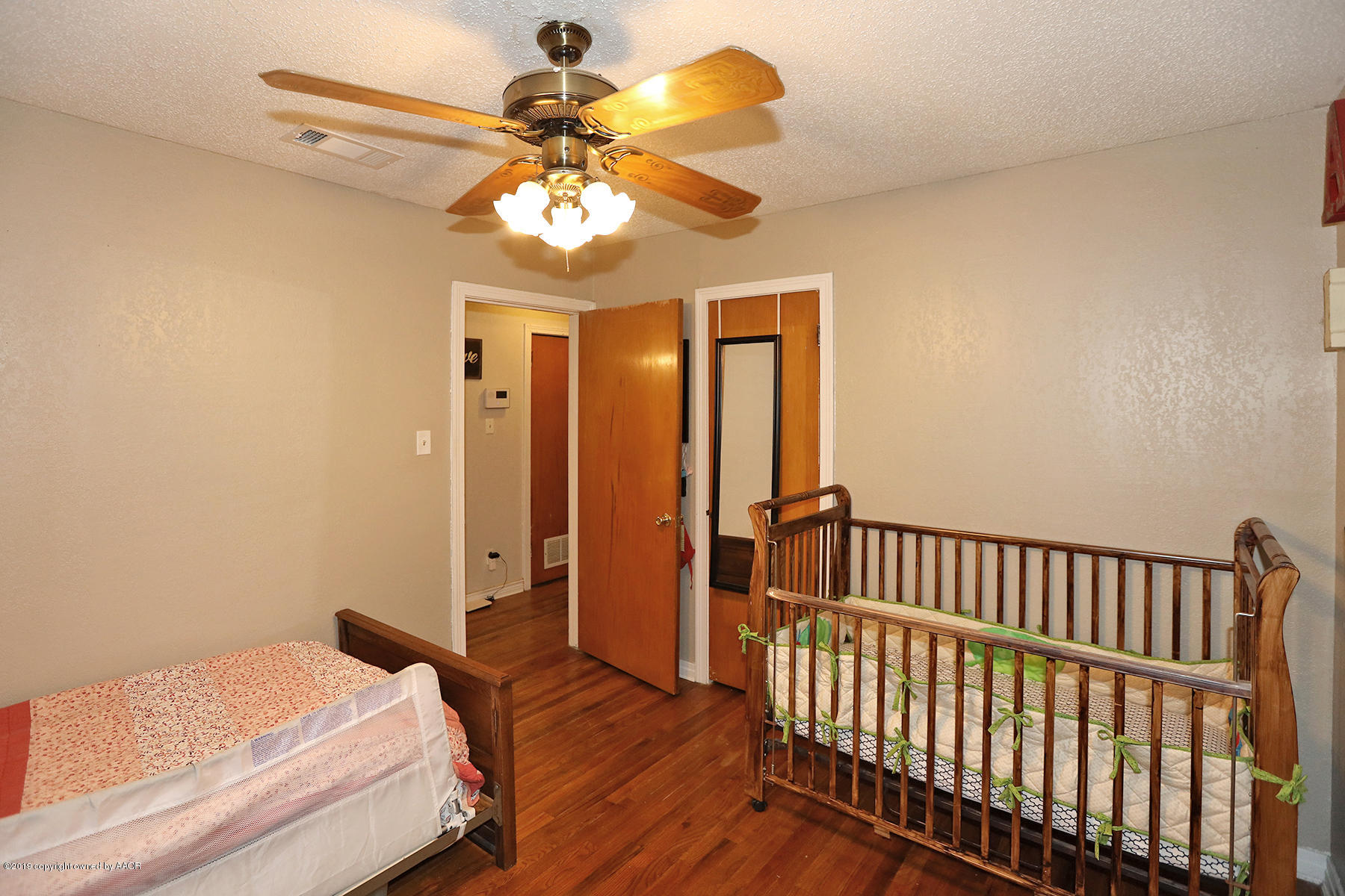 3814 South Monroe Street Amarillo, TX 79110 - Photo 12 of 22 a bedroom with bed and wooden floor