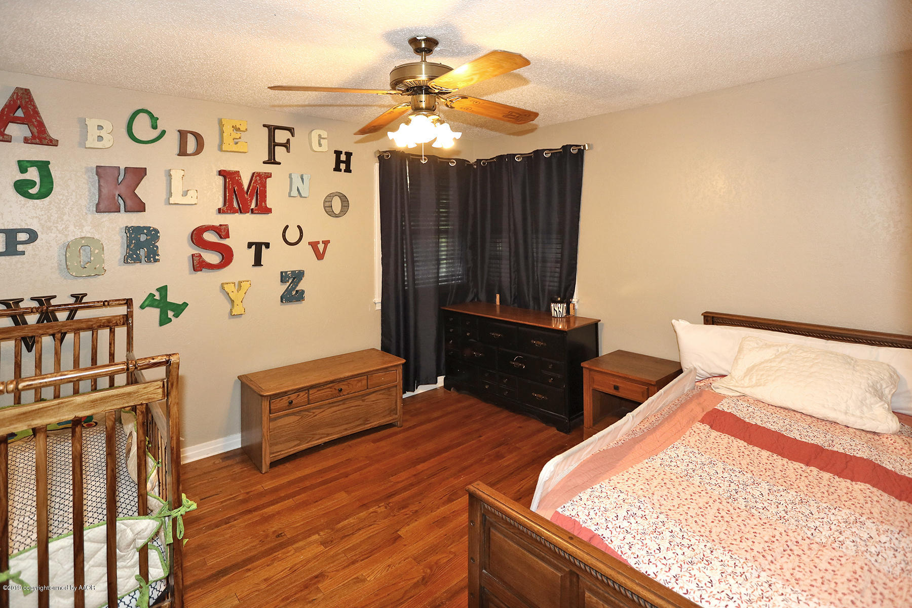 3814 South Monroe Street Amarillo, TX 79110 - Photo 13 of 22 a bedroom with furniture and wooden floor