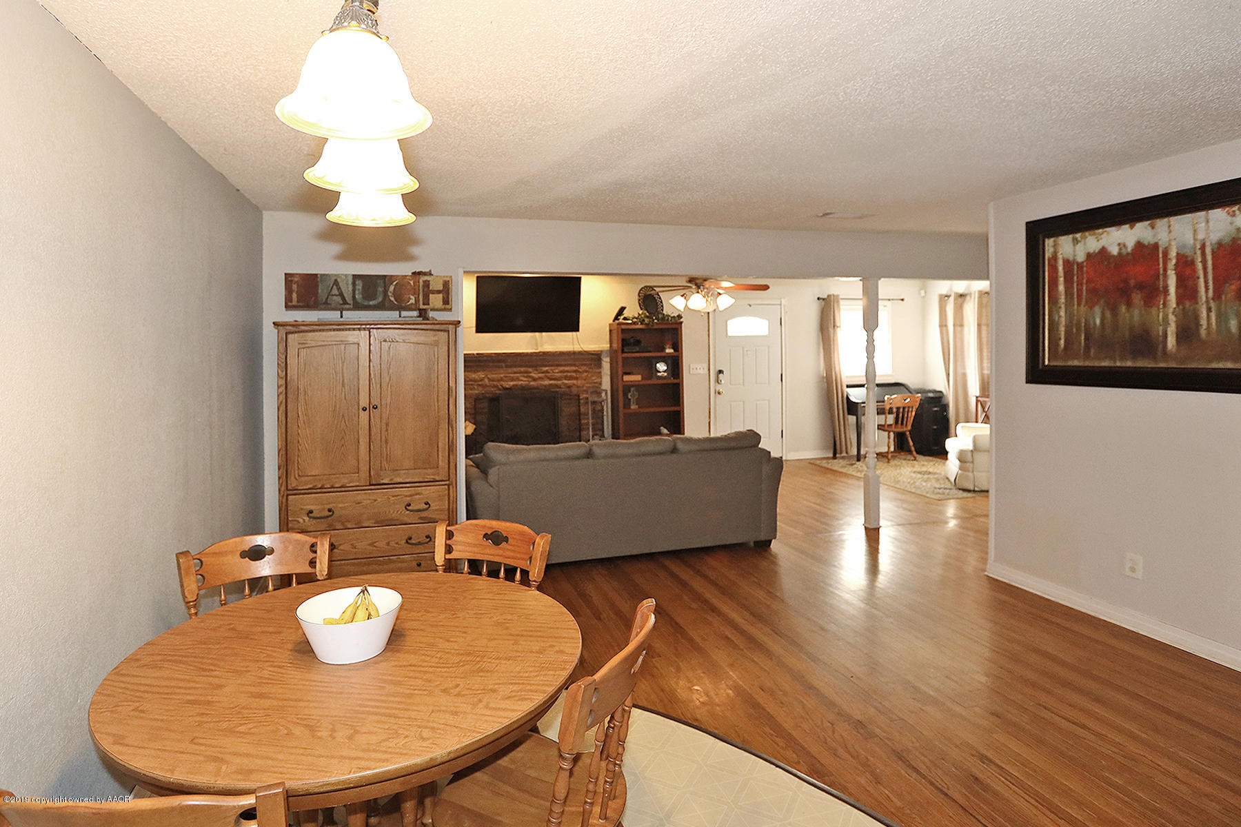 3814 South Monroe Street Amarillo, TX 79110 - Photo 7 of 22 a view of a dining room with furniture wooden floor and chandelier