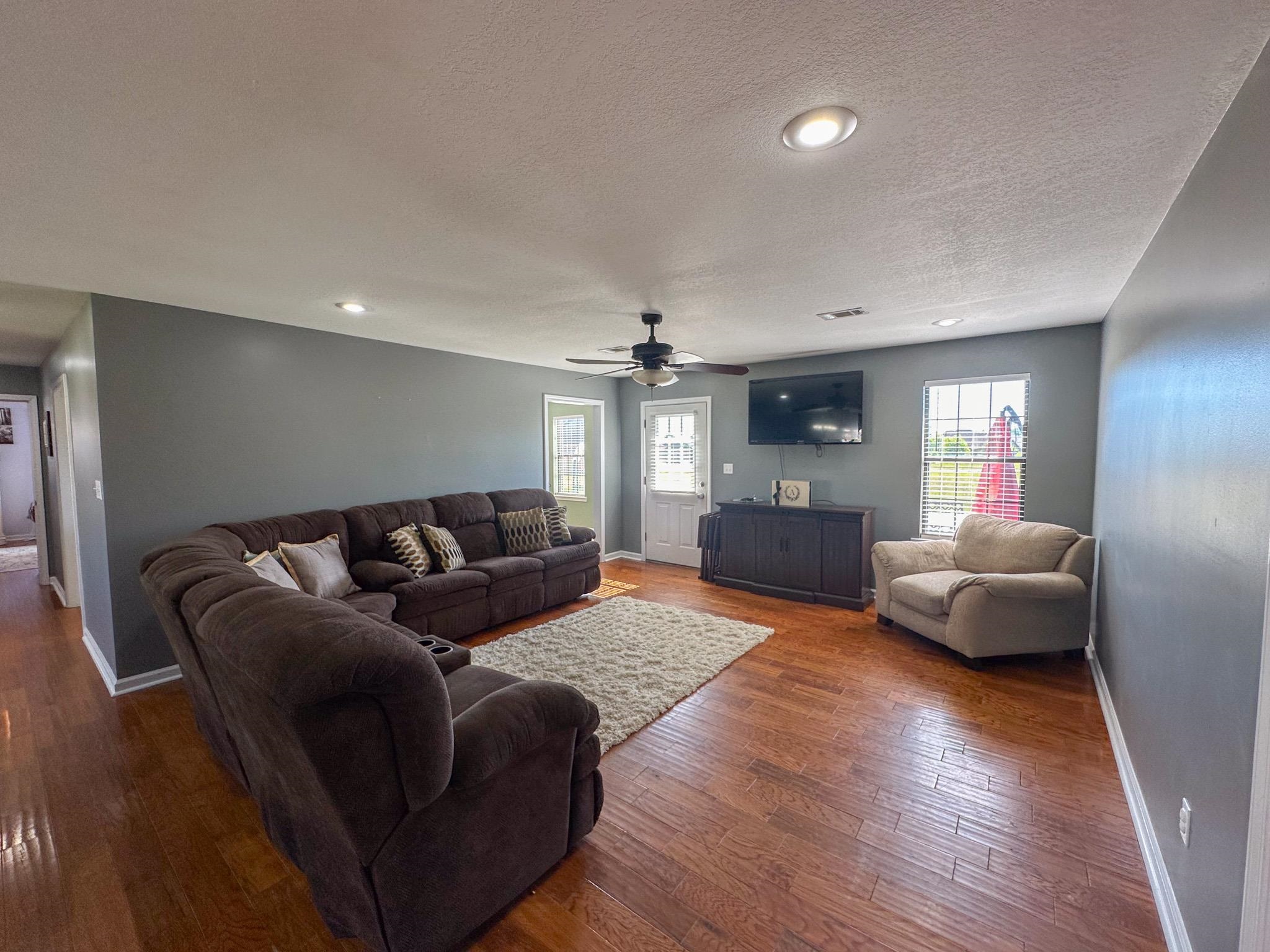 2 Raptor Drive Belmont, MS 38827 - Photo 3 of 18 Living room with a textured ceiling, wood-type flooring, and ceiling fan
