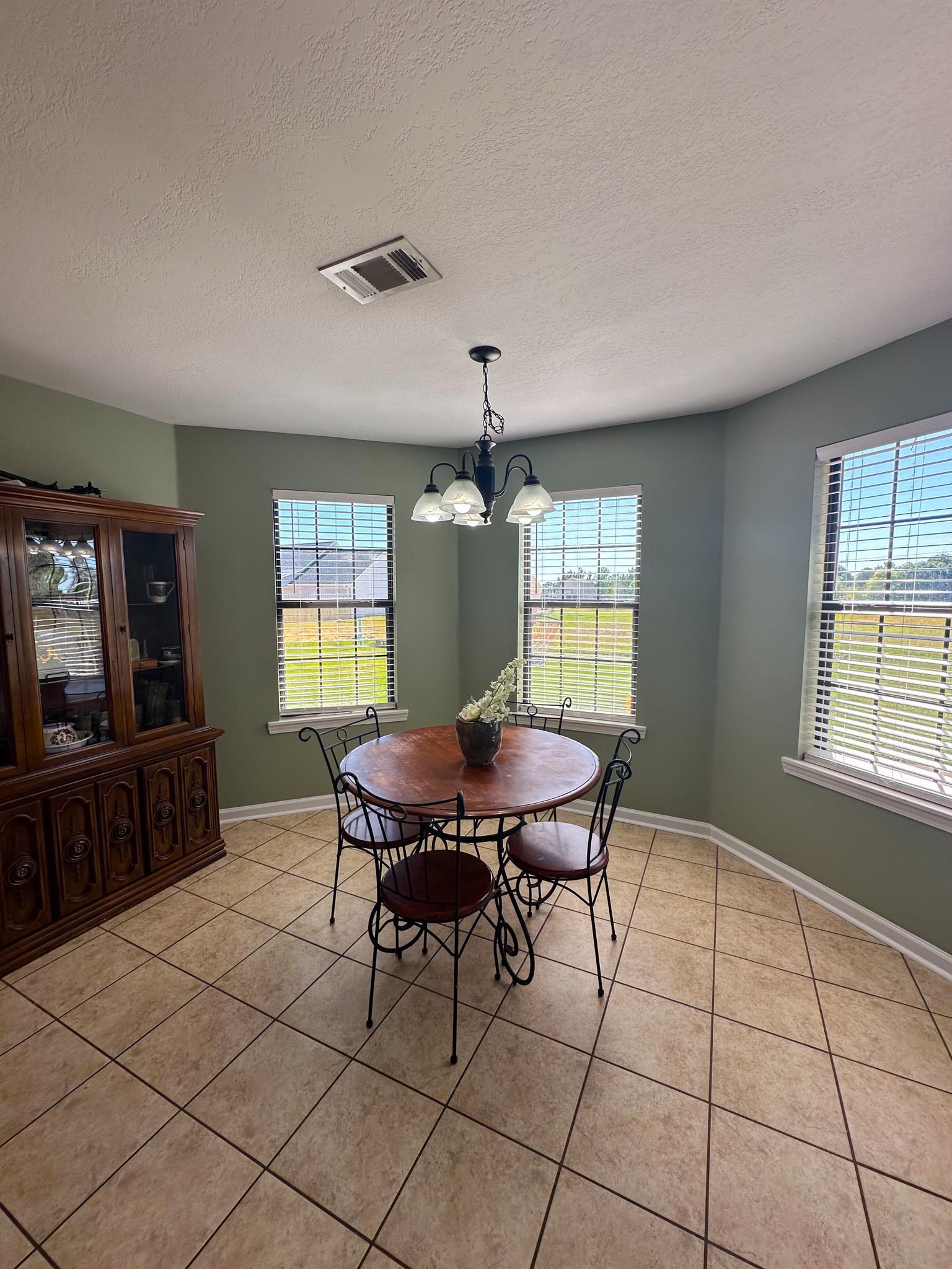 2 Raptor Drive Belmont, MS 38827 - Photo 7 of 18 Dining room with plenty of natural light, a textured ceiling, tile patterned floors, and an inviting chandelier