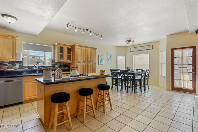a kitchen with stainless steel appliances granite countertop a sink and cabinets