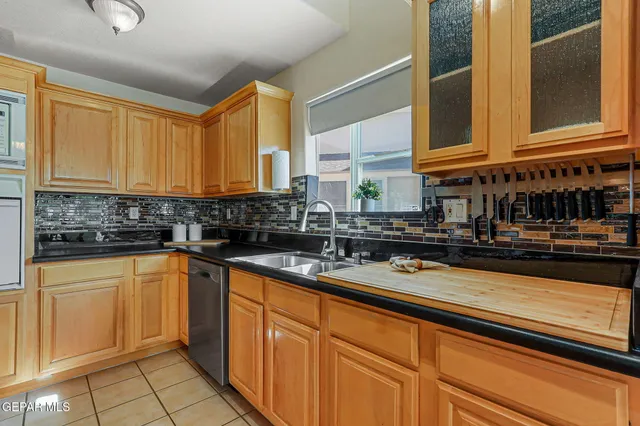a spacious bedroom with a bed a dresser and a window