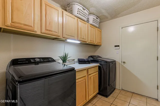 a bedroom with a bed and chandelier